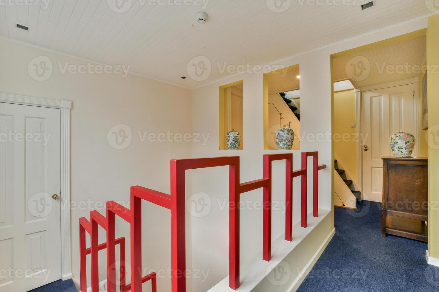 A stairway with red railings photo