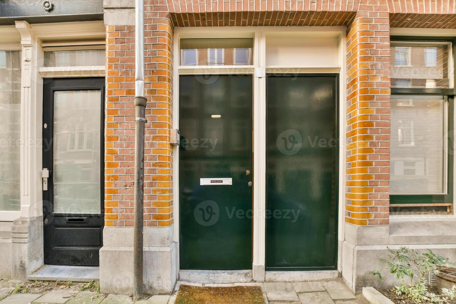A brick building with green doors and windows photo