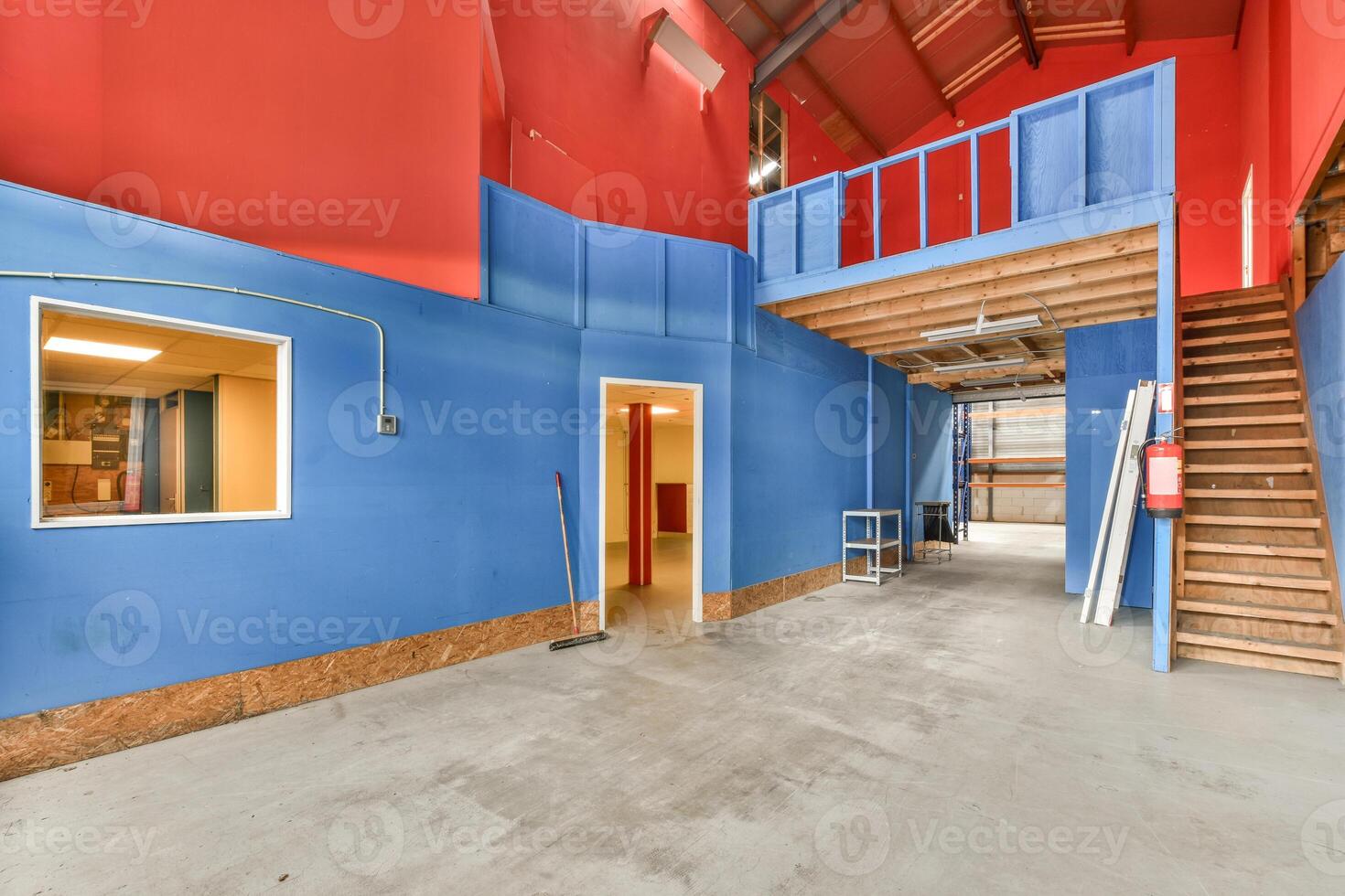 A room with blue walls and red stairs photo