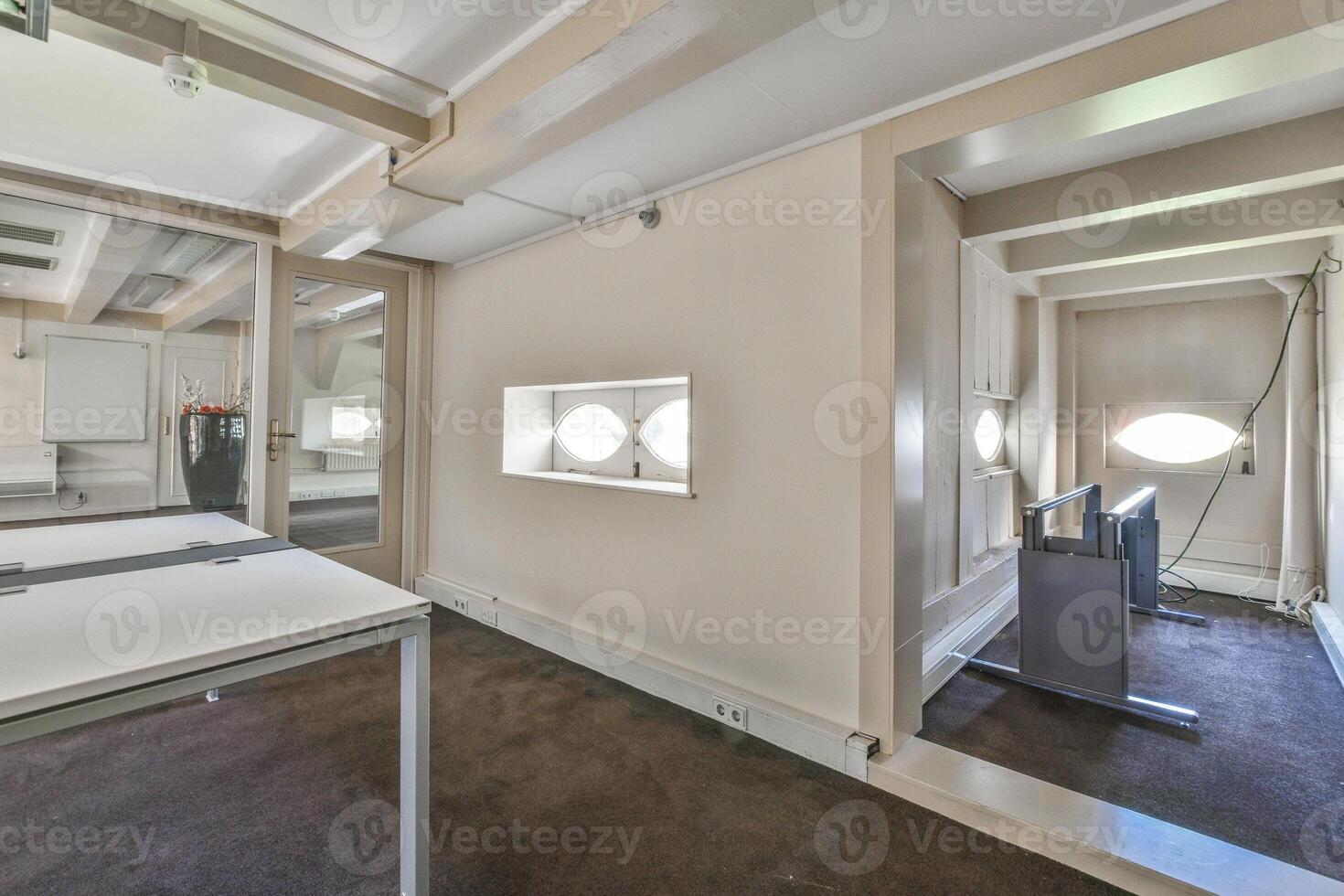 A room with a desk and a mirror in it photo