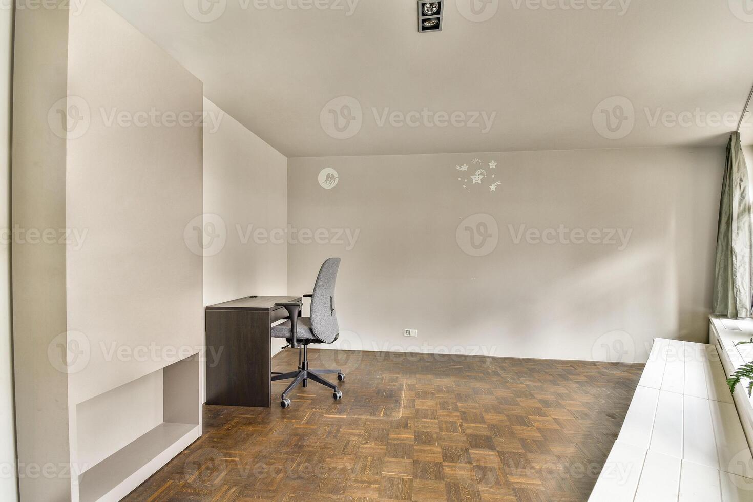 A room with a desk and a window photo