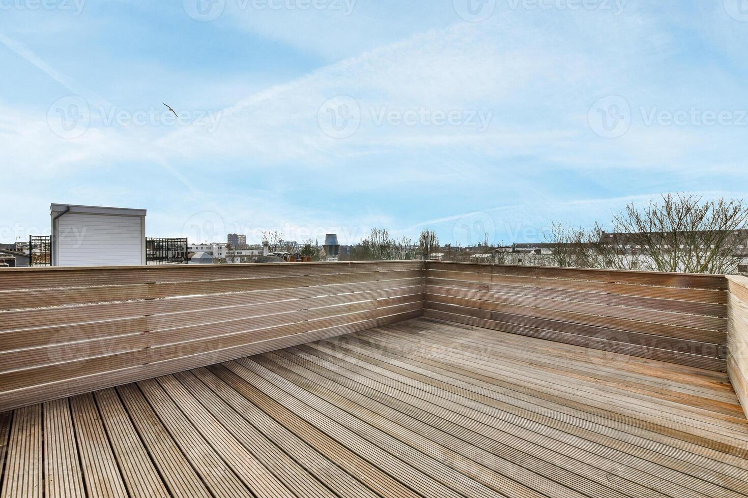 A wooden deck with a view of the city photo