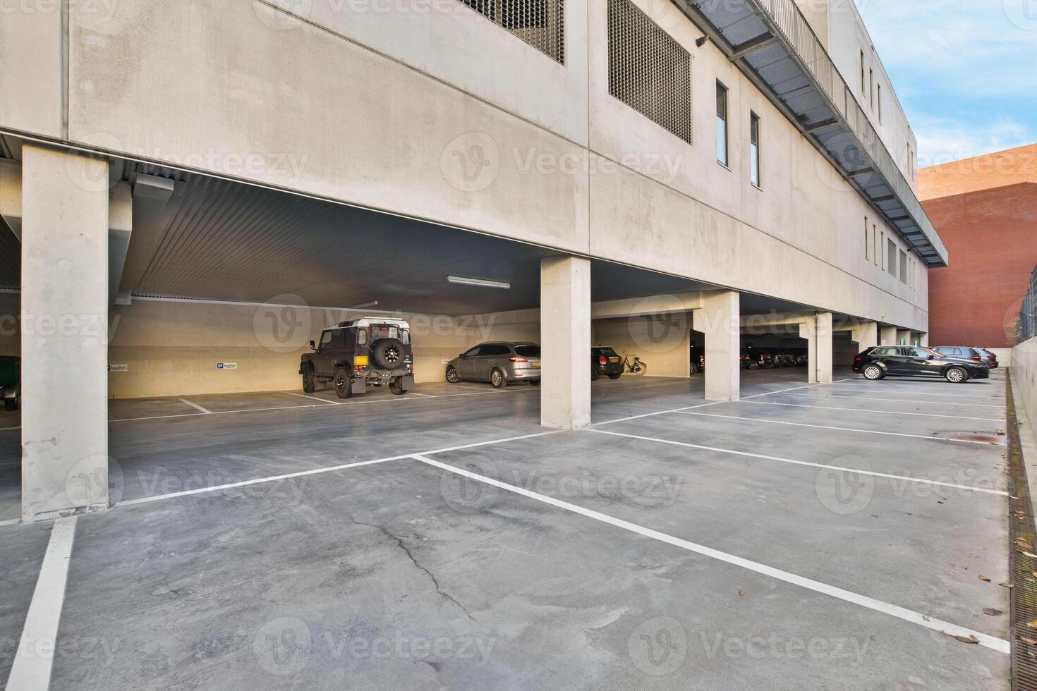 An empty parking garage with two cars parked in it photo
