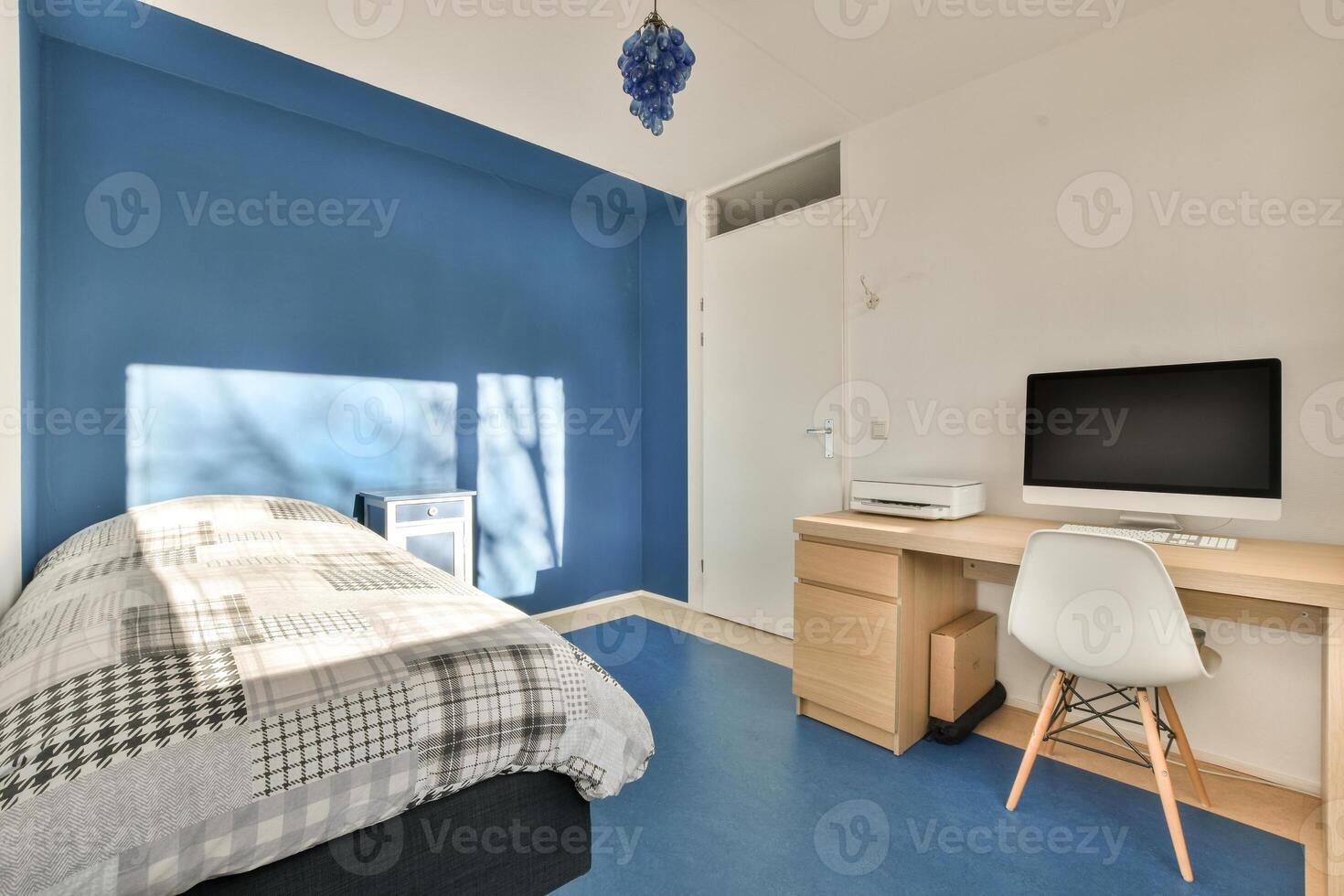A bedroom with a desk and a bed photo
