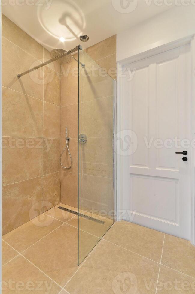 A bathroom with a glass shower and a toilet photo