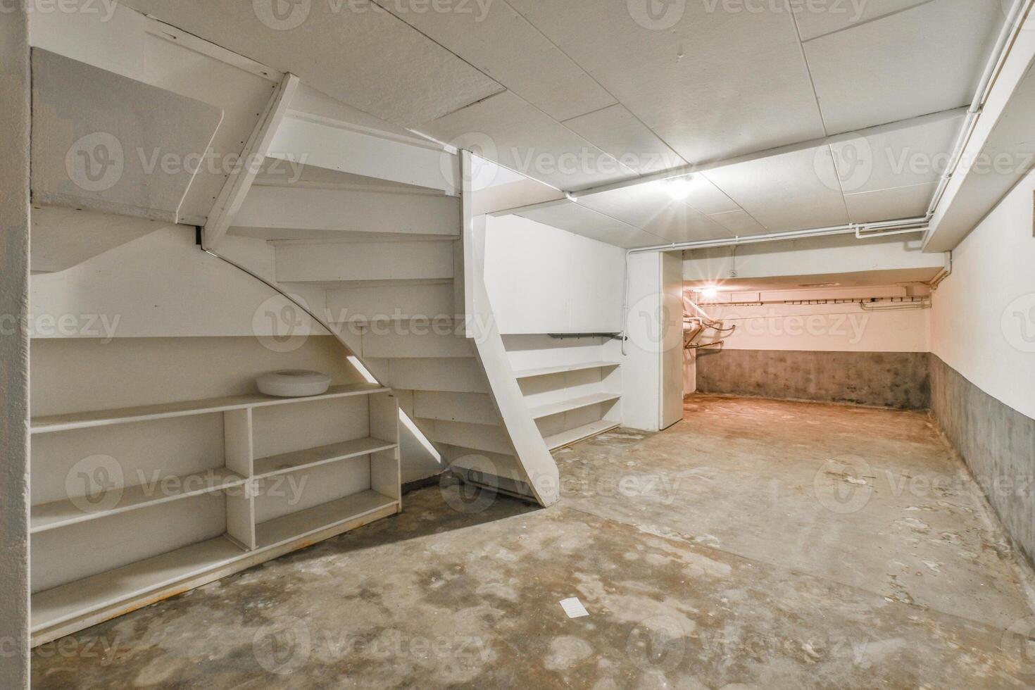 A basement with a staircase and a shelf photo
