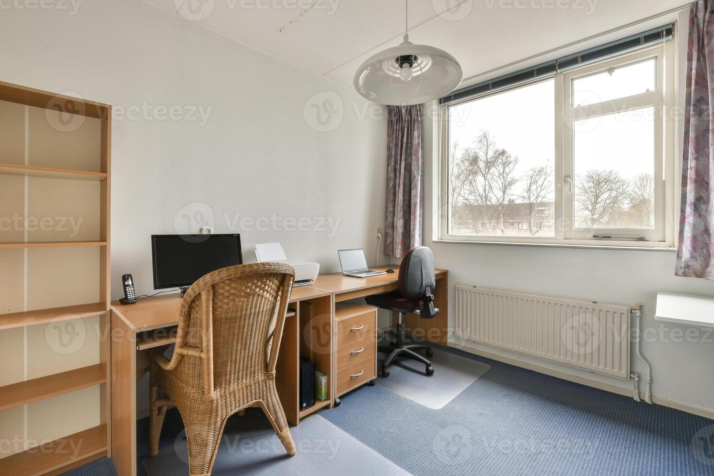 A home office with a desk, chair and computer photo