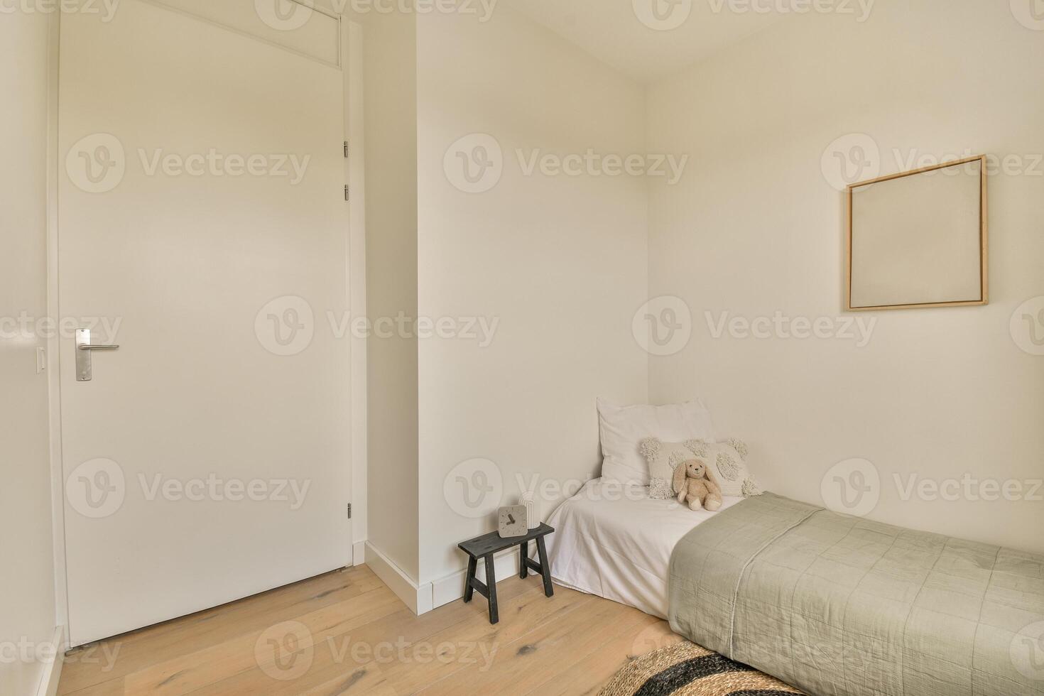 A bedroom with a bed, a chair and a wall photo
