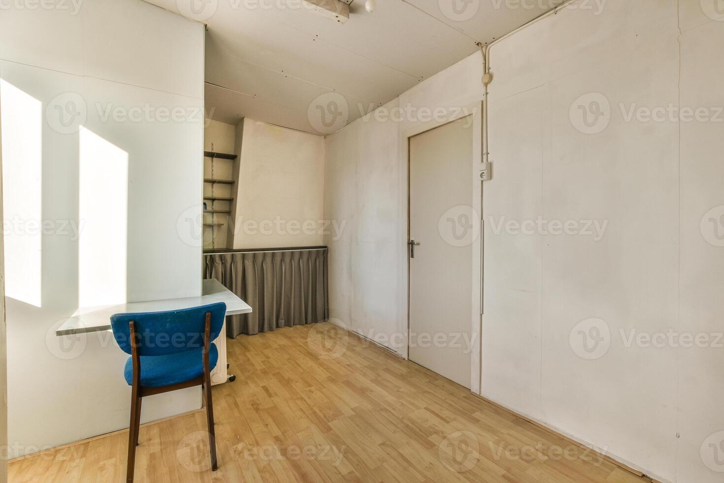 A room with a desk and chair in it photo