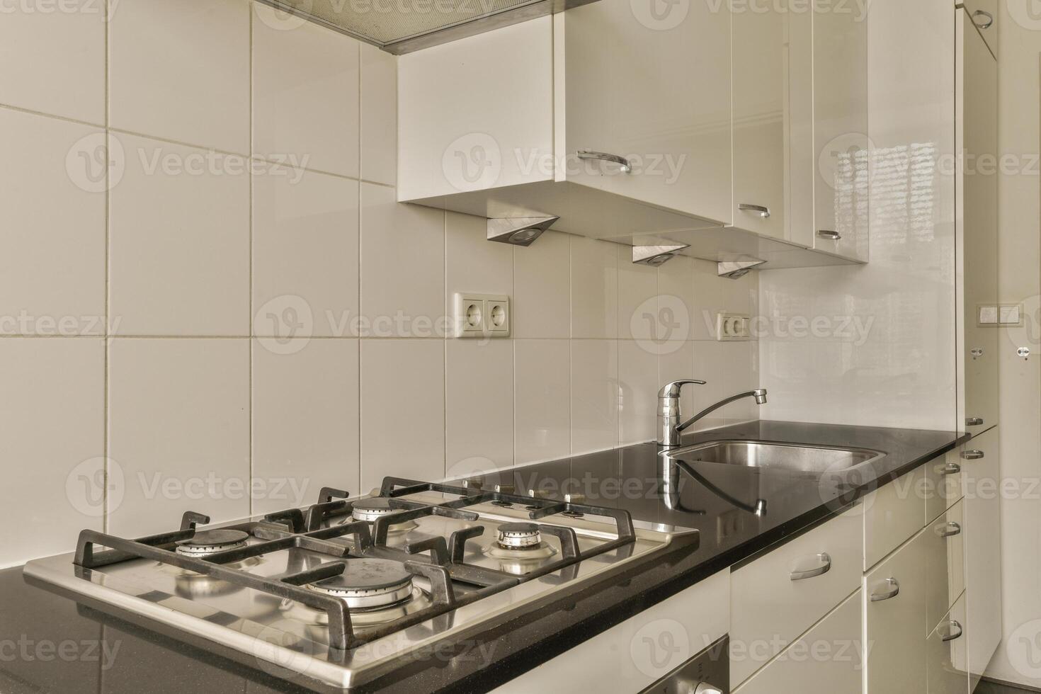 A kitchen with a stove and sink photo