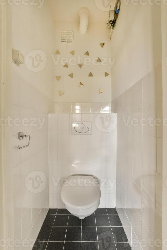 A bathroom with a toilet and a wall with triangles photo