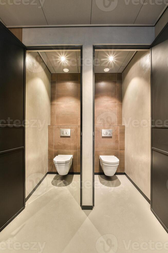 A bathroom with two toilets and a sink photo