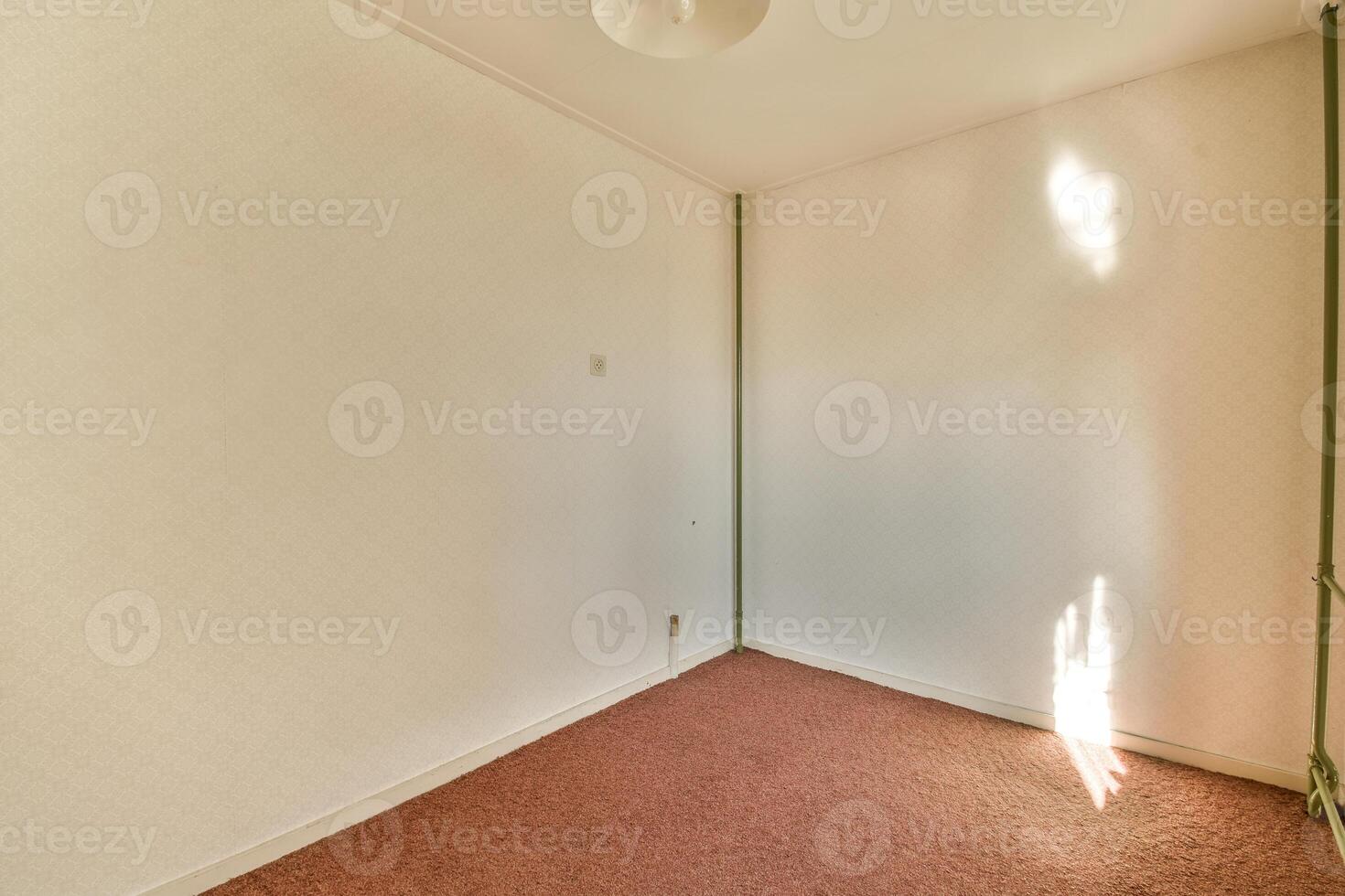 An empty room with a light shining through the window photo