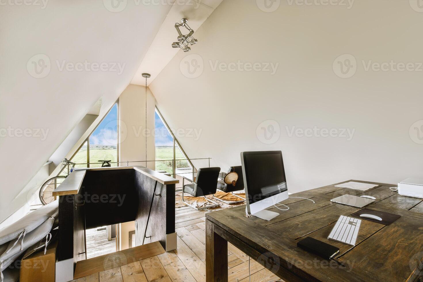A home office with a desk and a window photo