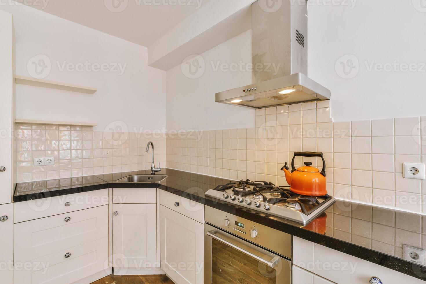 A kitchen with a stove and oven photo