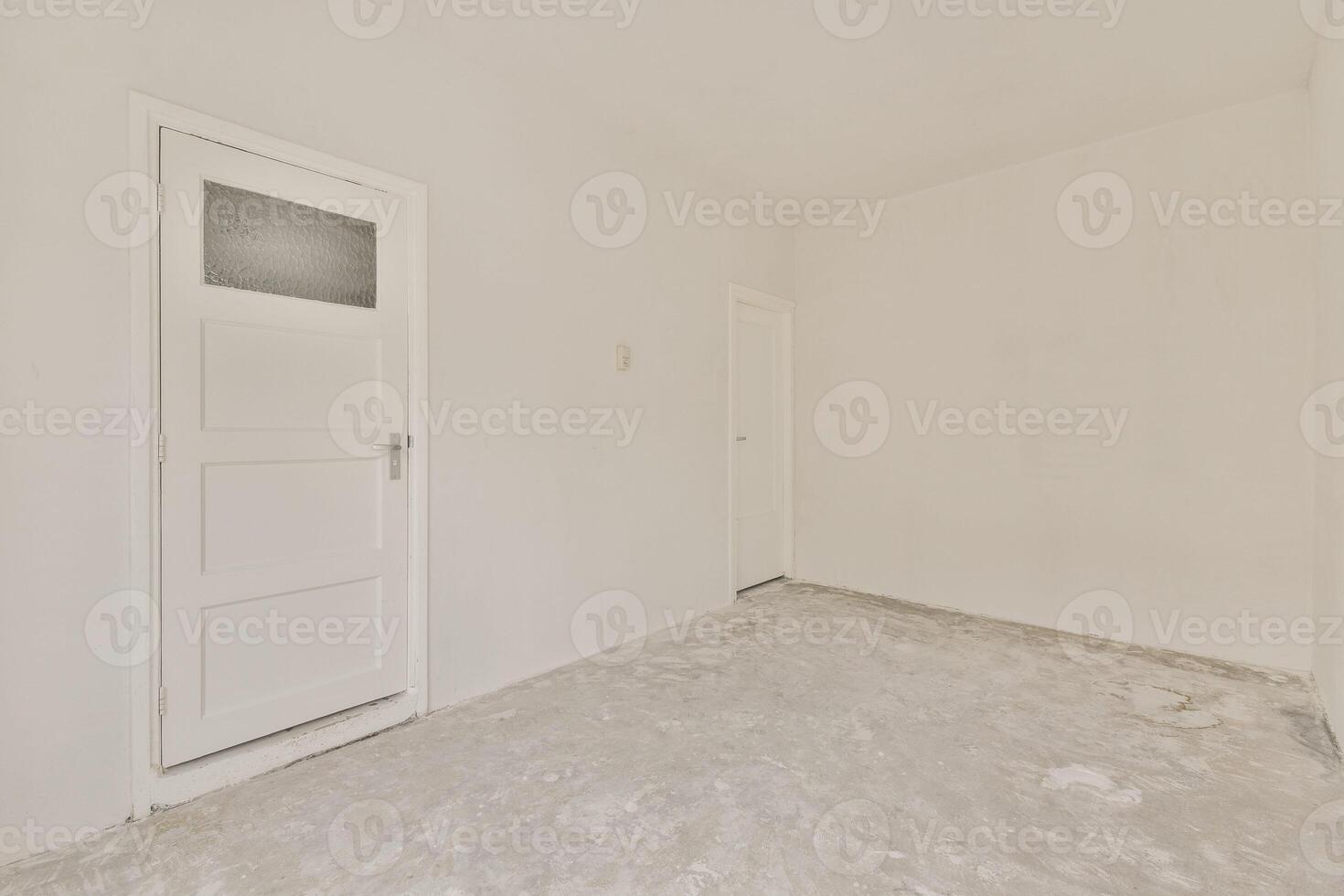 An empty room with a door and a white wall photo