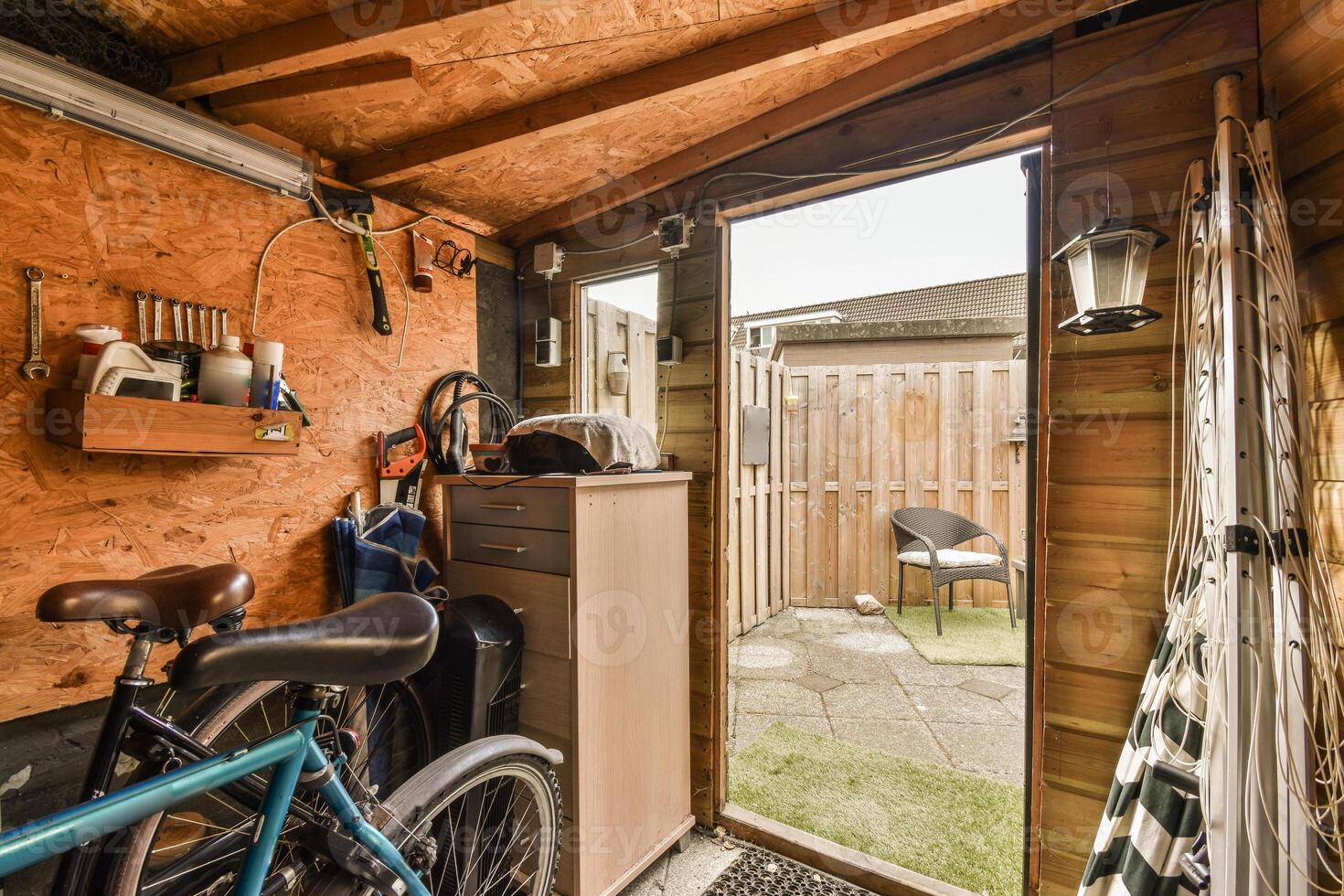 A bike is parked in a garage with a door open photo