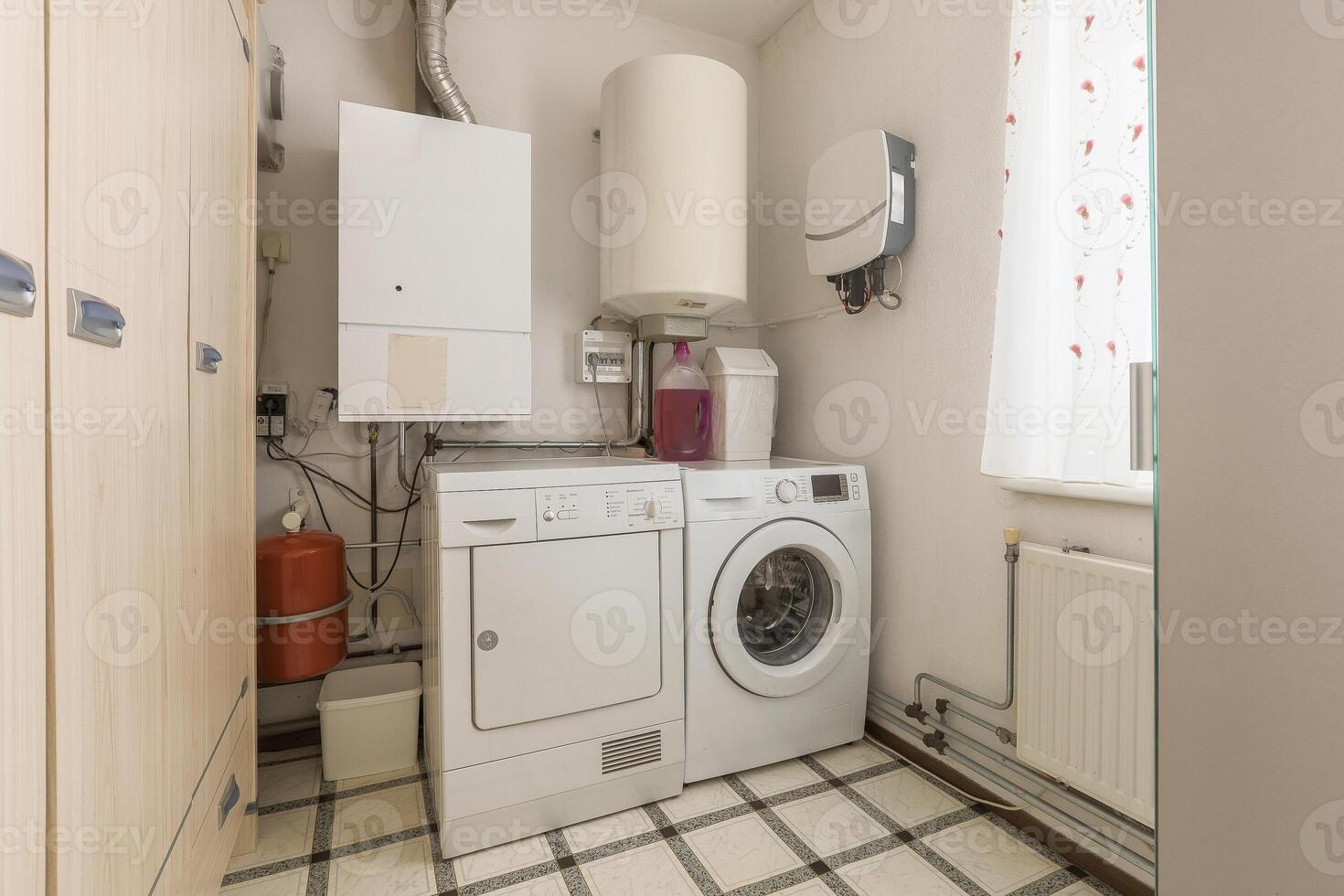 A small laundry room with a washer and dryer photo