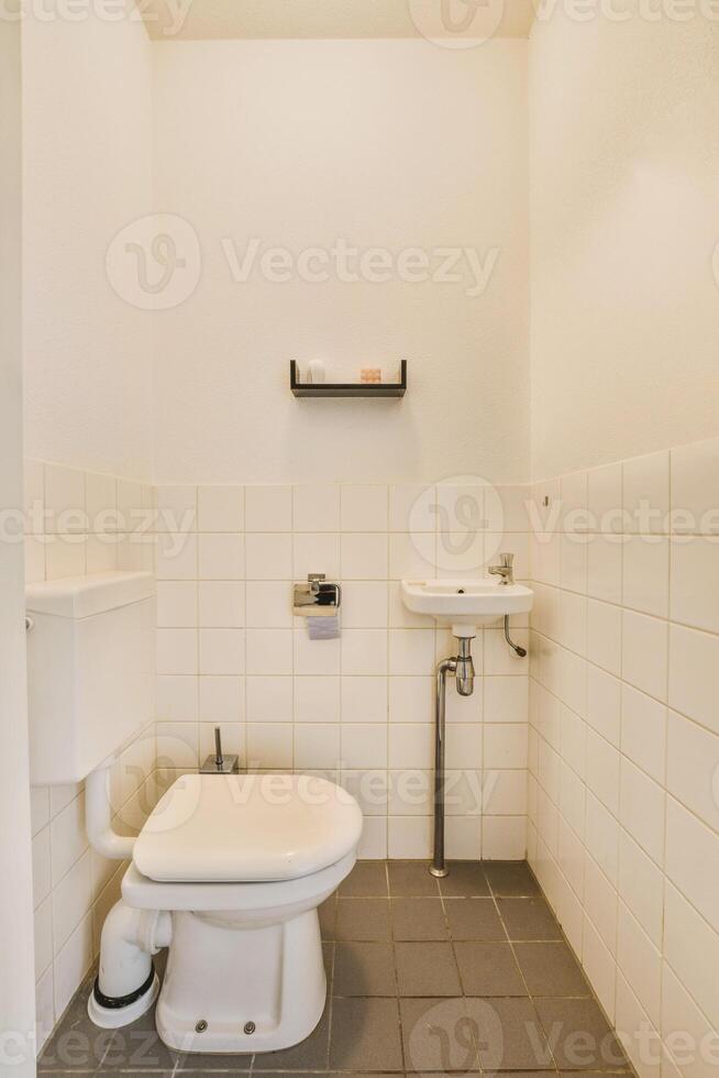 A white toilet in a bathroom photo