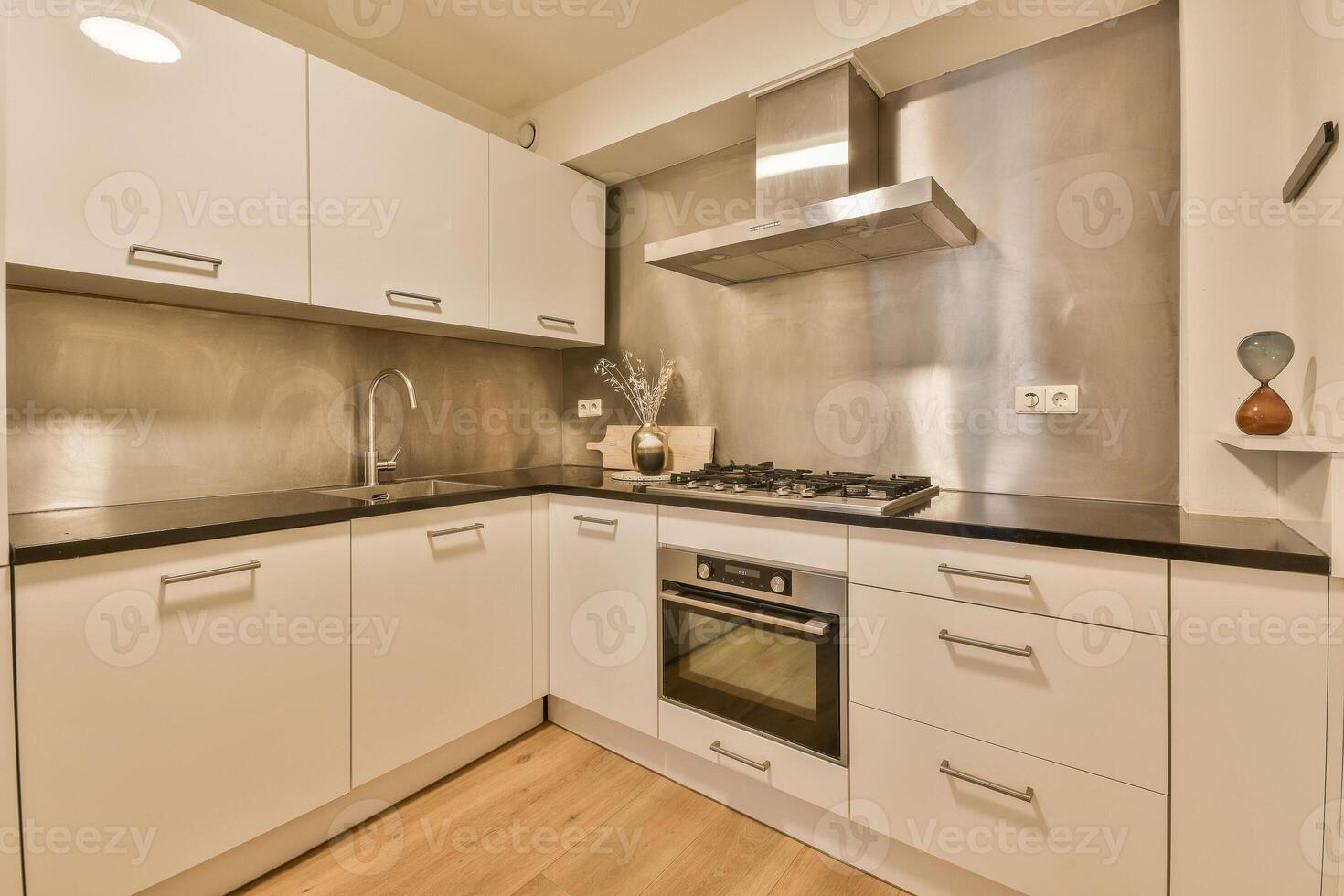 A kitchen with a stove and oven photo