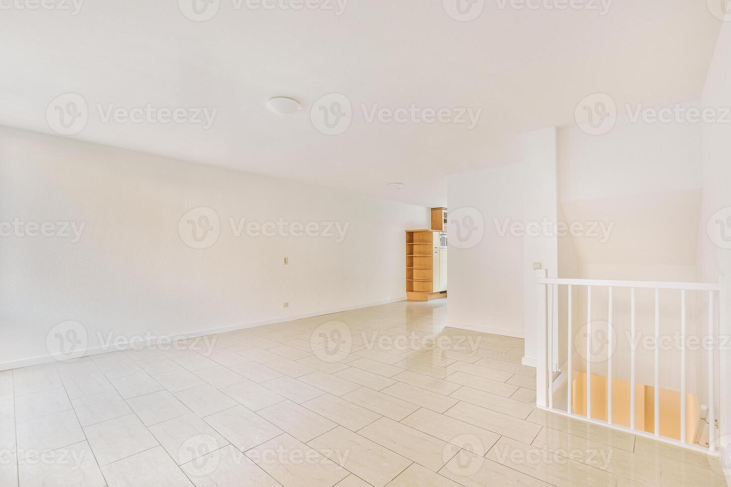 A white room with tile floors and a white door photo