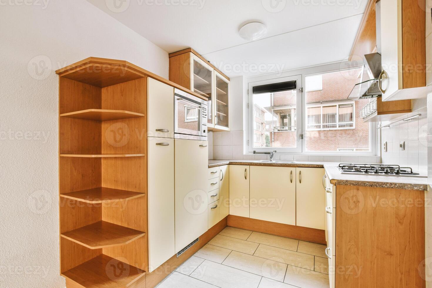 A kitchen with a white counter top and a wooden cabinet photo