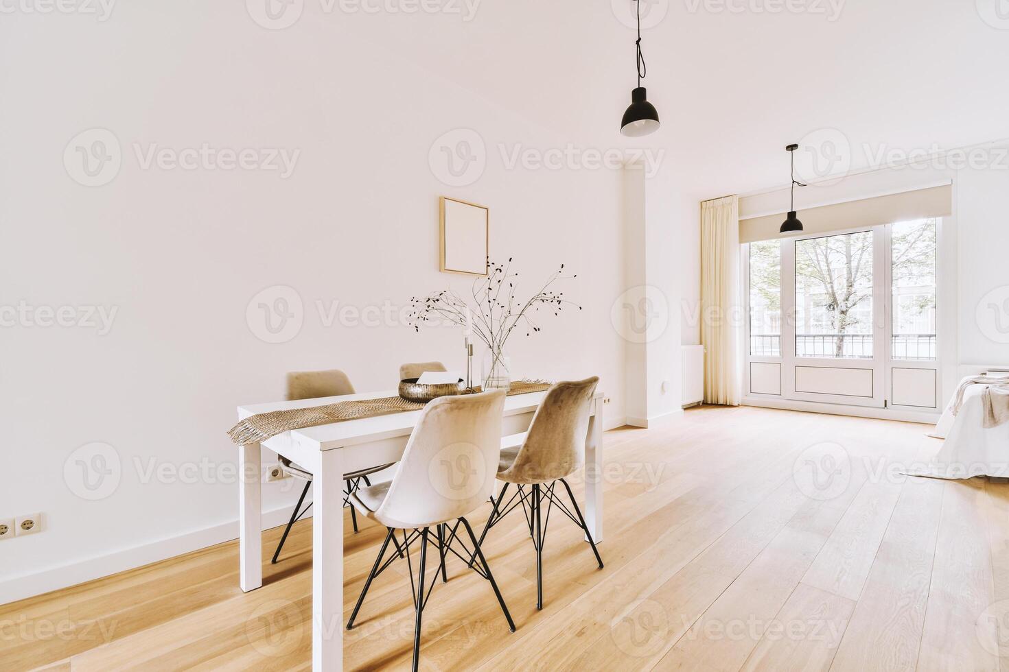 A white dining room with a table and chairs photo