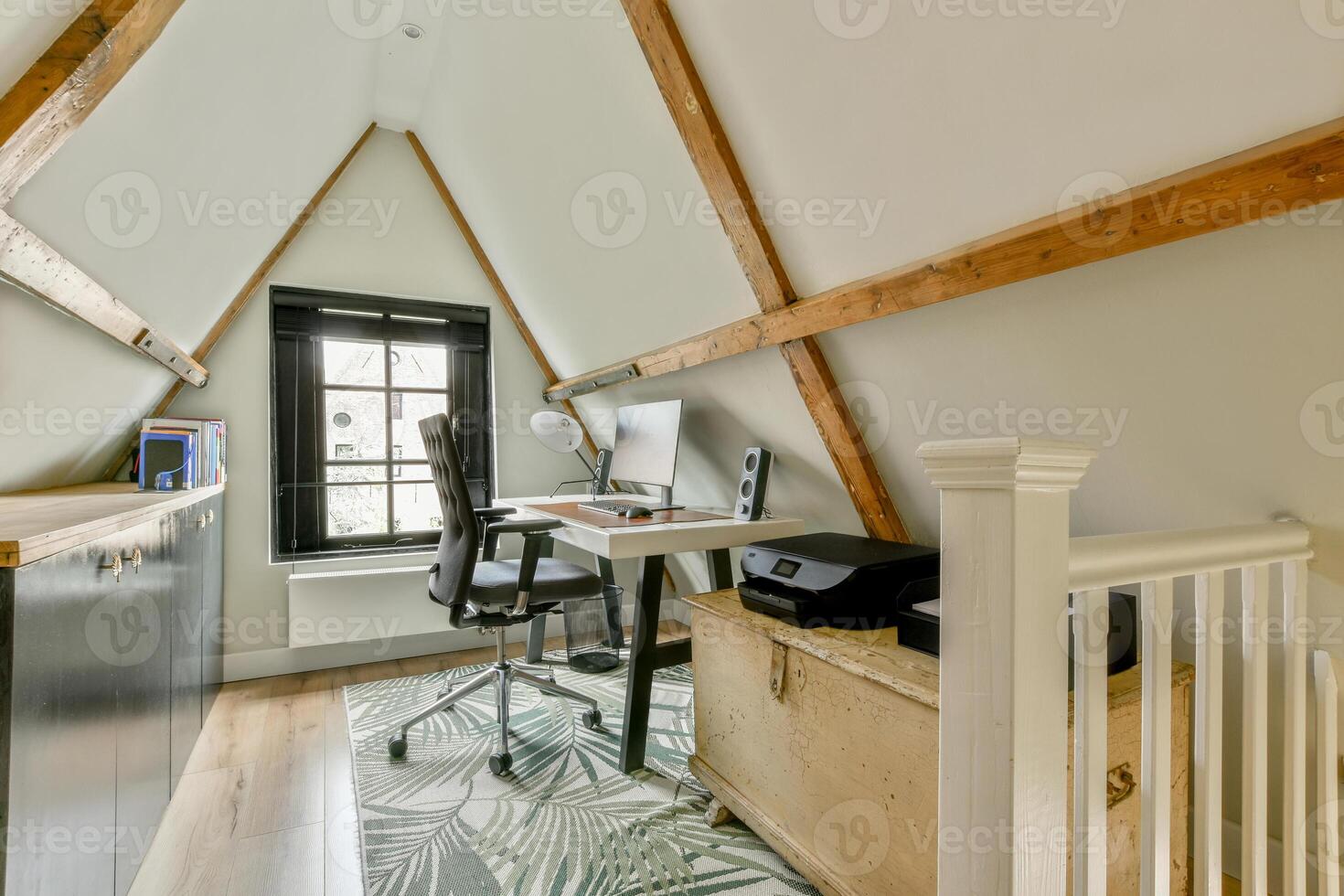 A home office with a desk and chair photo