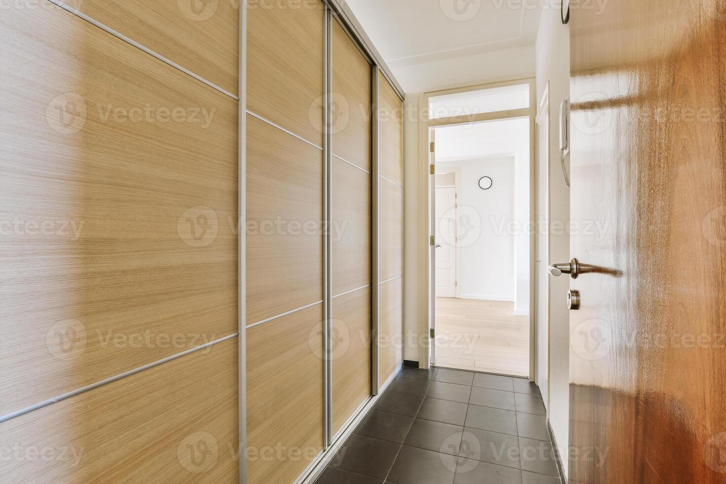 A hallway with wooden doors and a white door photo