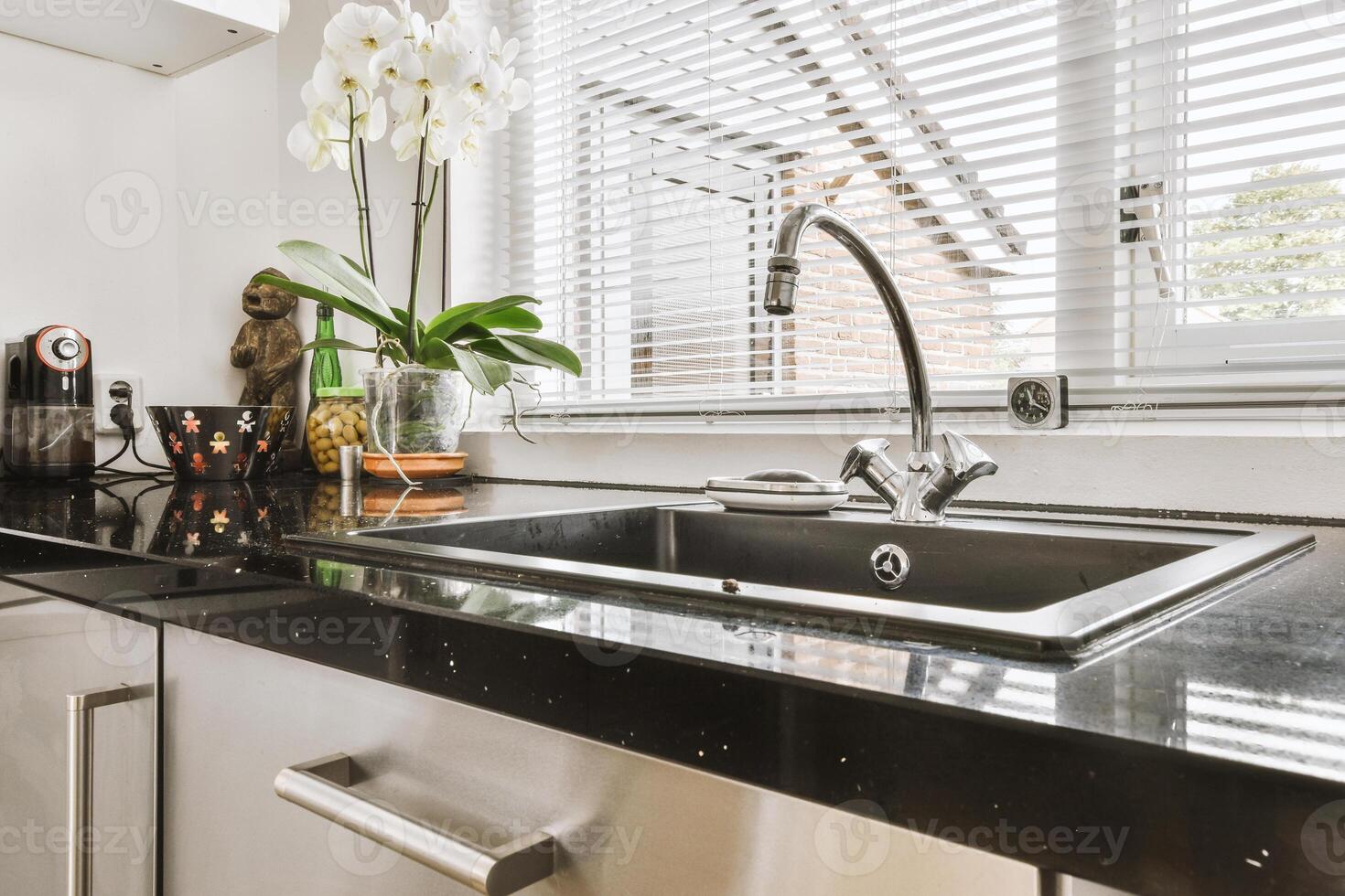 A kitchen with a sink and a window photo