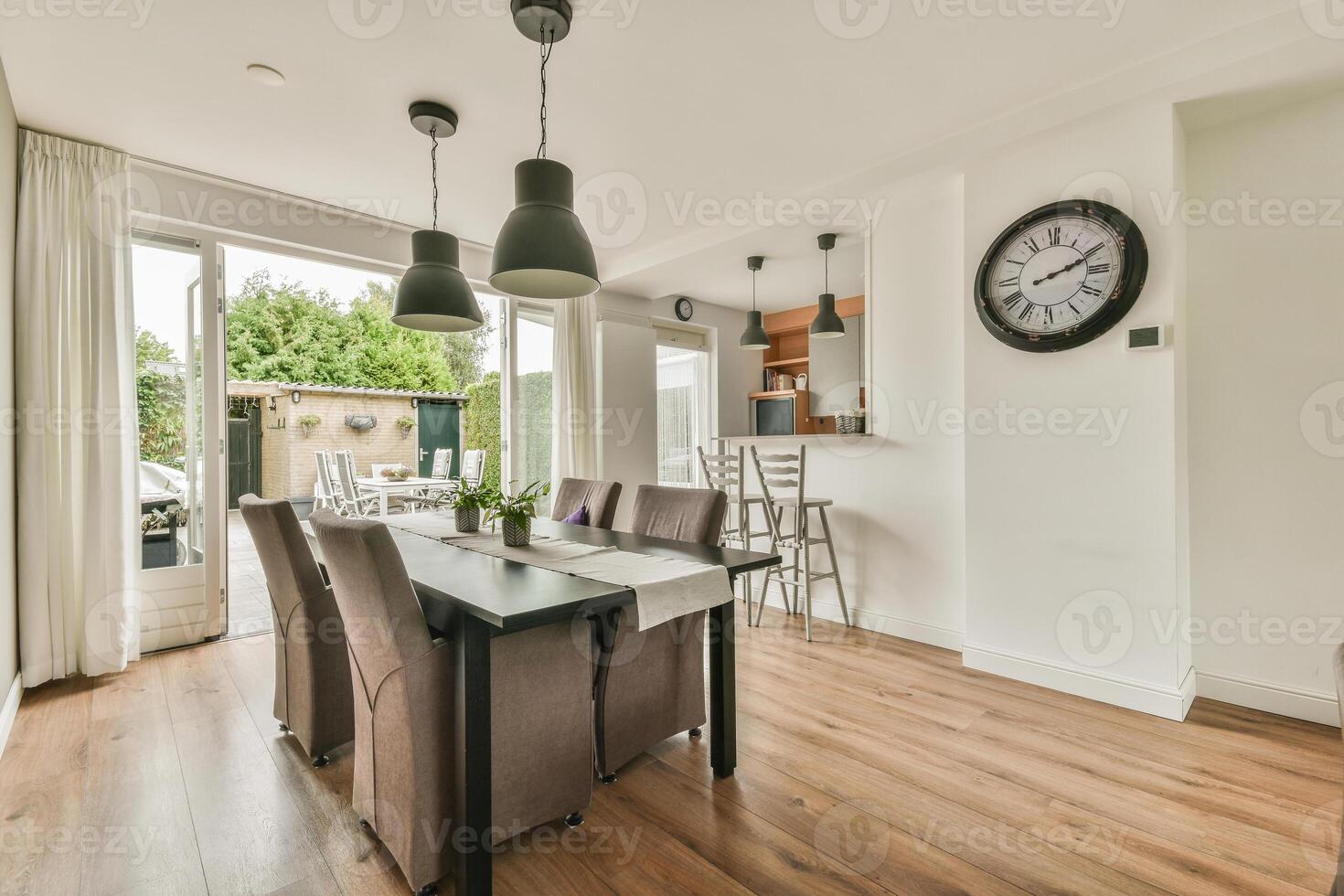 A dining room with a table and chairs photo