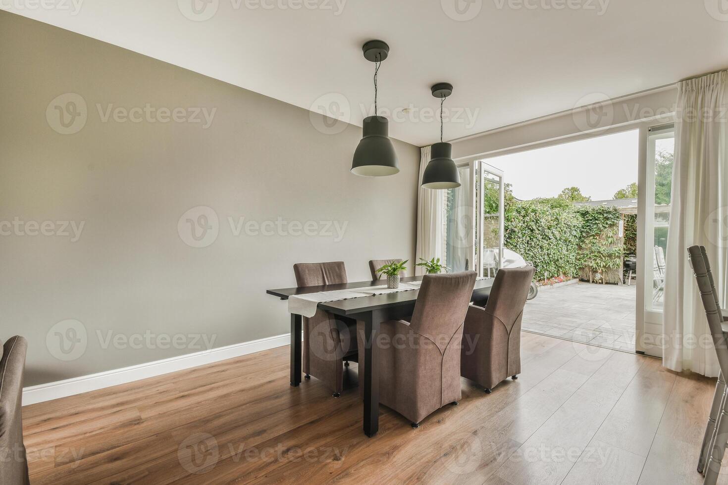 A dining room with a table and chairs photo