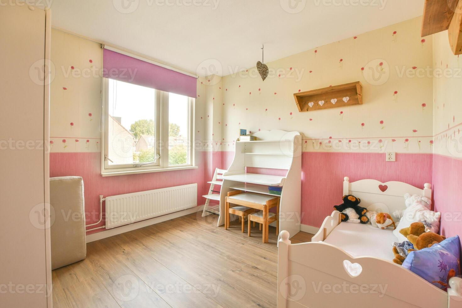 A room with a bed, desk, and a window photo