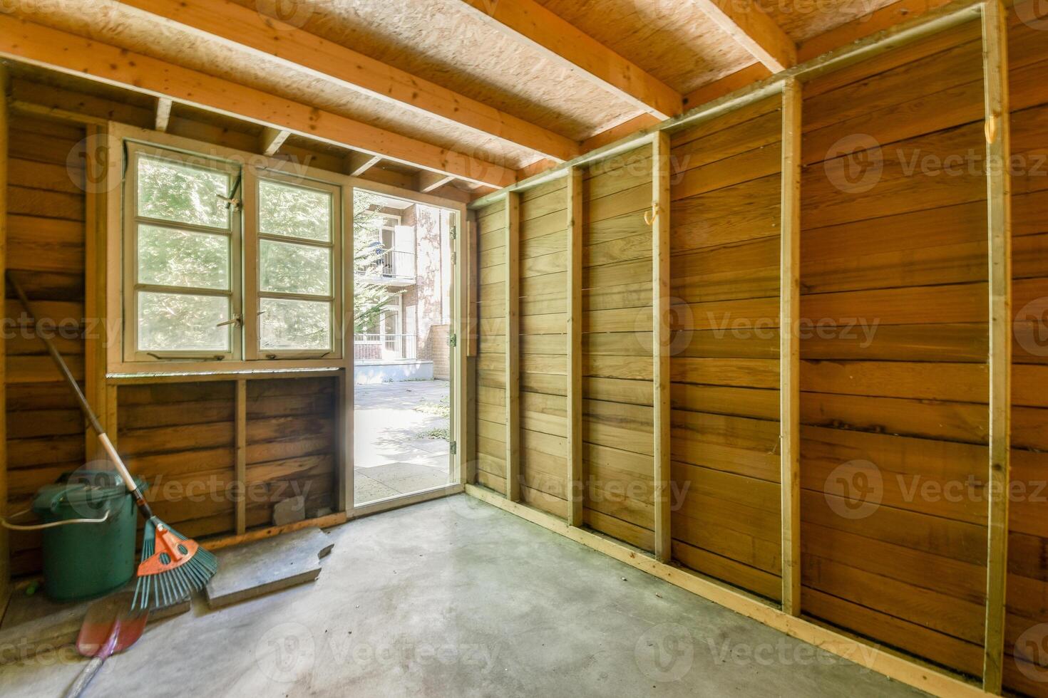A room with wooden walls and a window photo