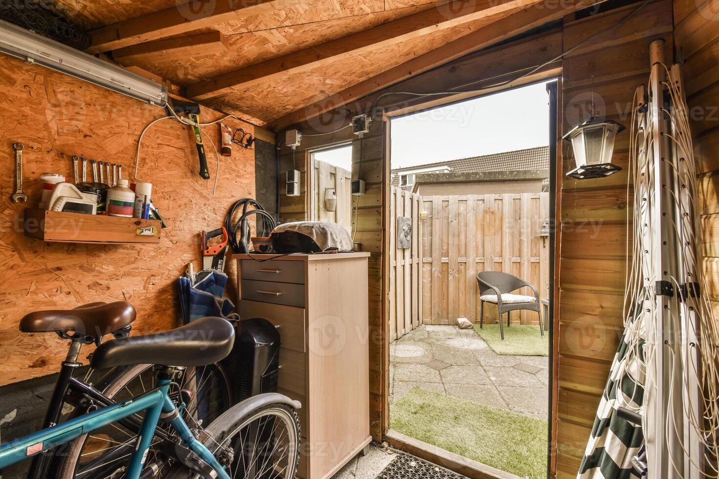 A bike is parked in a garage with a door open photo