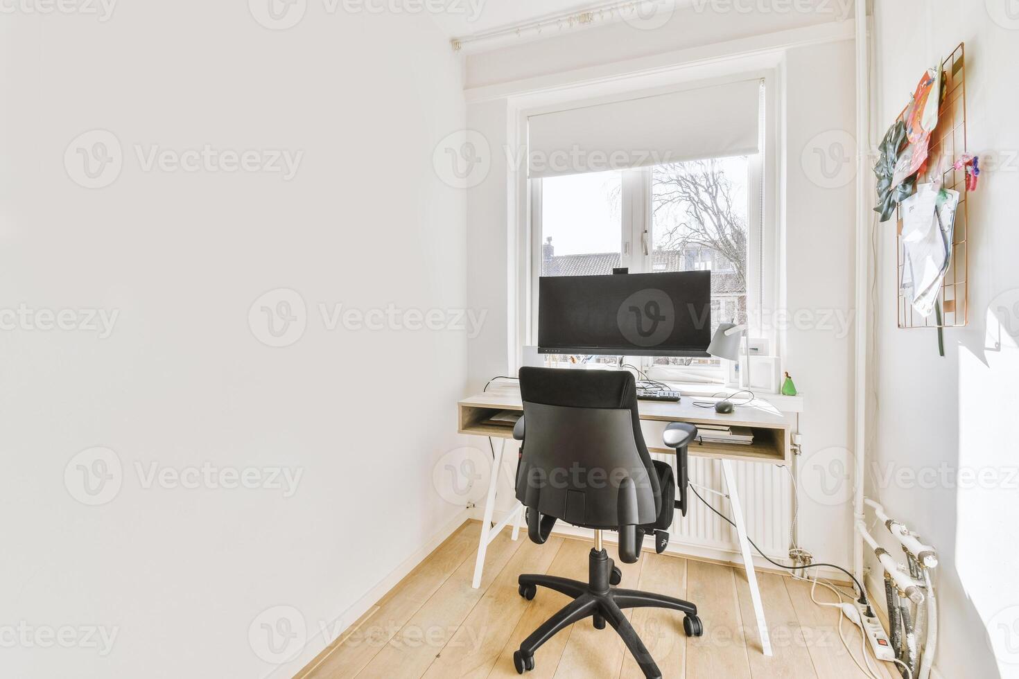 A white desk with a computer and a chair photo