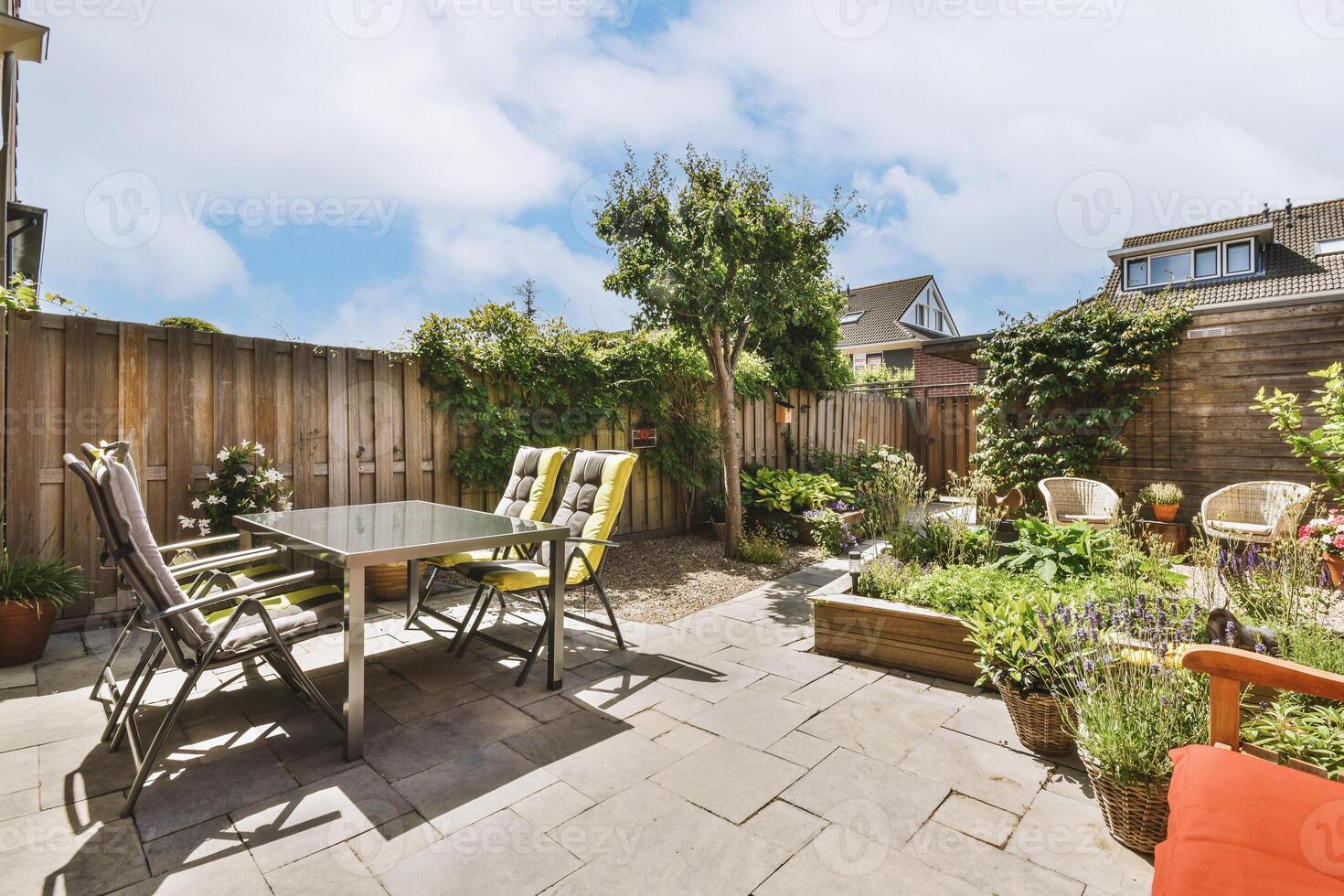 A patio with a table and chairs in the backyard photo
