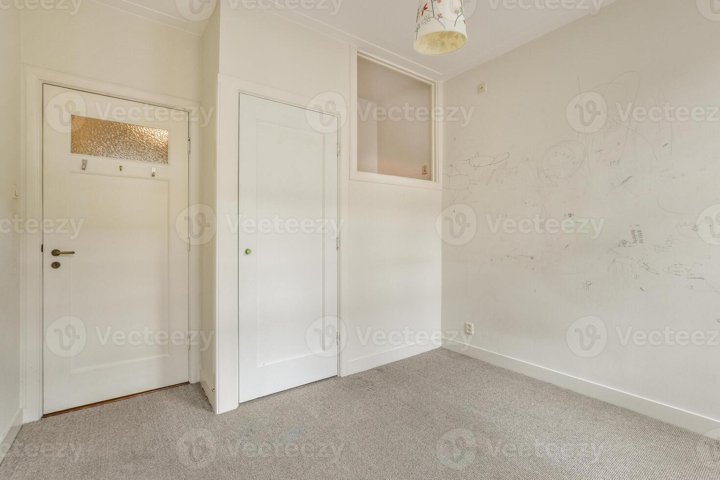 A white door in a room with a wall covered in drawings photo