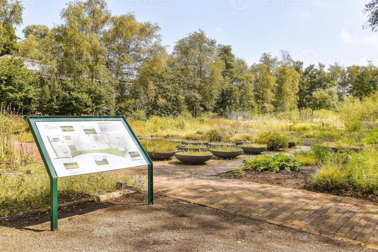 A sign on a green metal stand photo