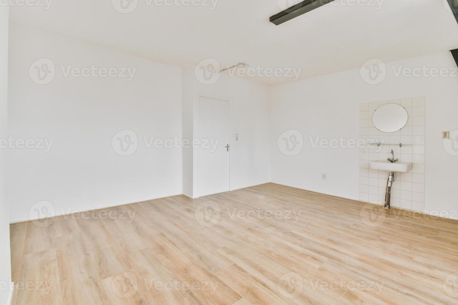 An empty room with a sink and toilet in it photo