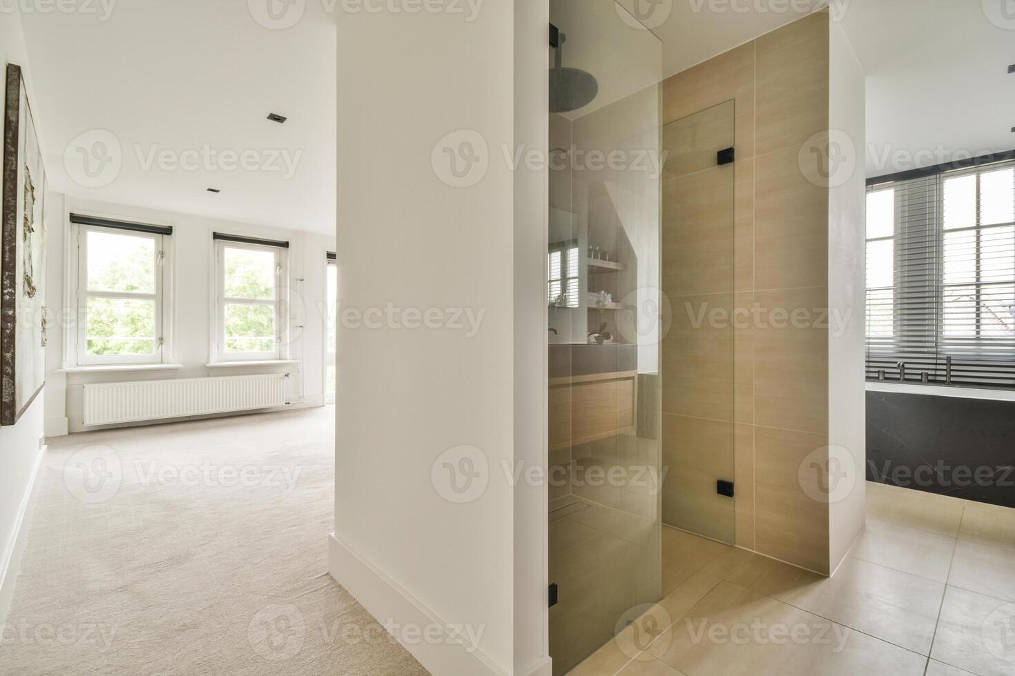 A bathroom with a glass shower door and a toilet photo