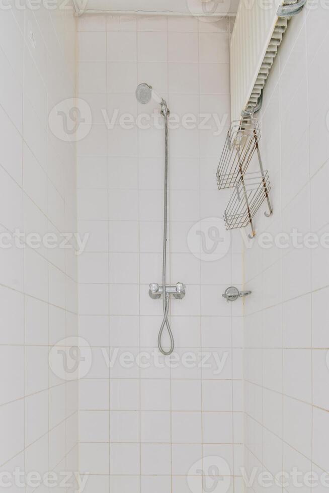 A shower with a shower head and a shower rod photo