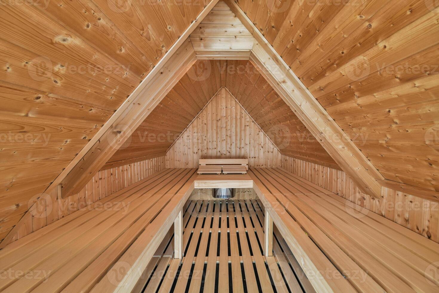 A sauna room with wooden walls and a bench photo