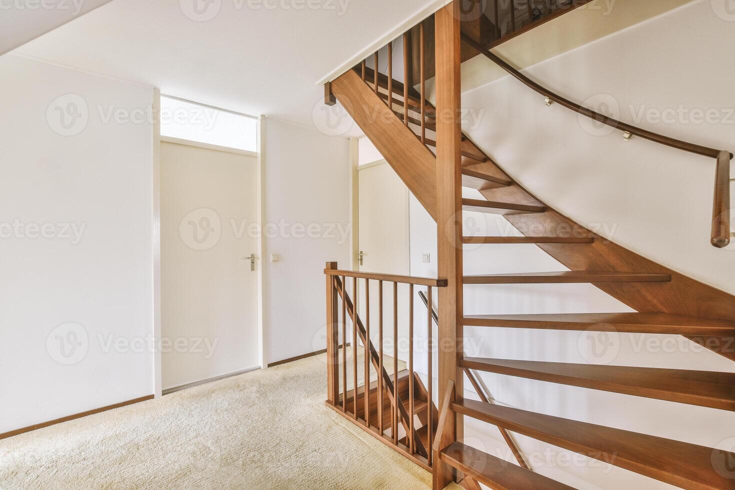 A staircase in a house with a carpeted floor photo