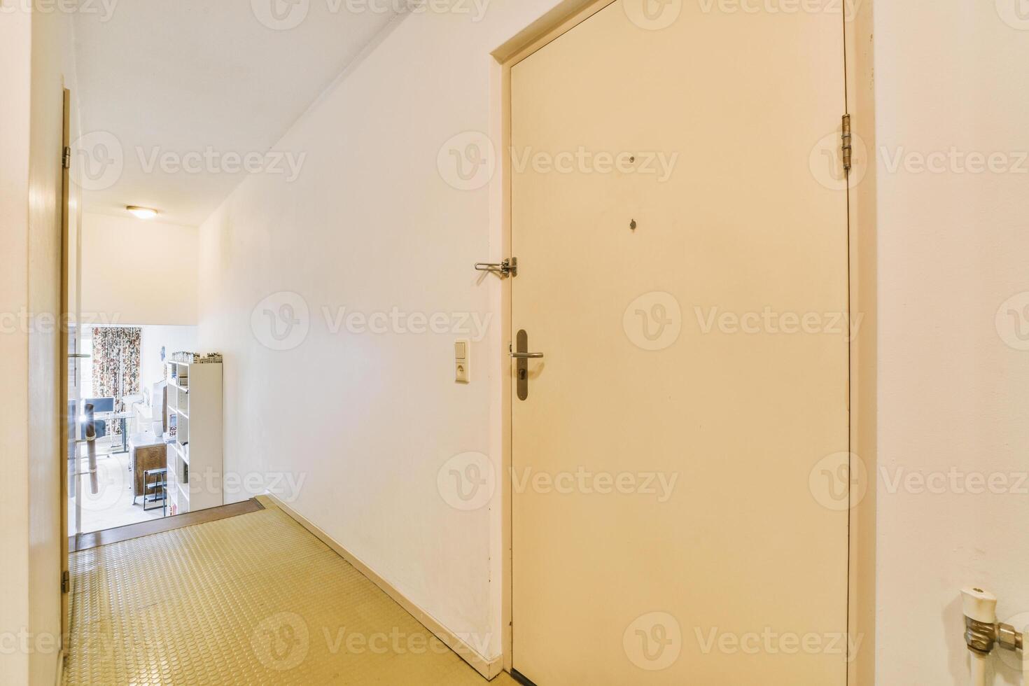 A hallway with a door and a yellow floor photo