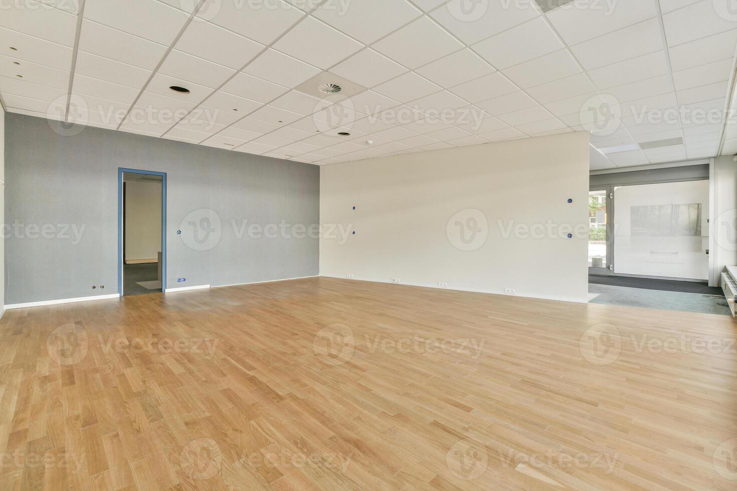 An empty room with wooden floors and white walls photo
