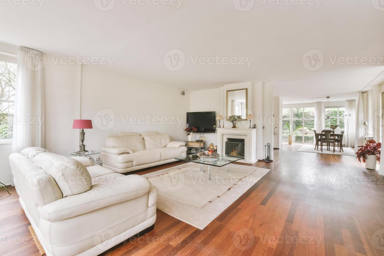 A living room with white furniture and wooden floors photo