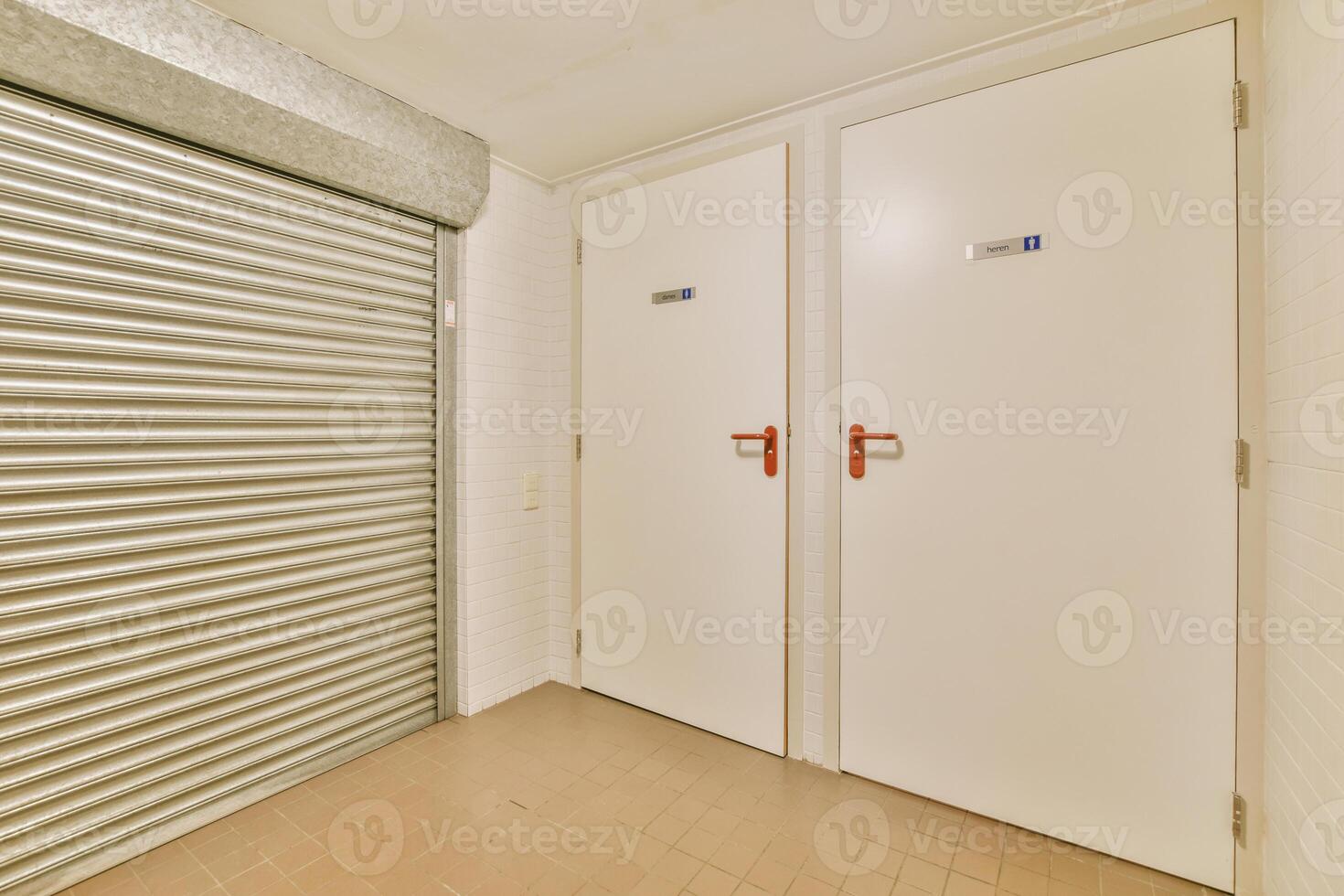 A storage room with two doors and a roller door photo