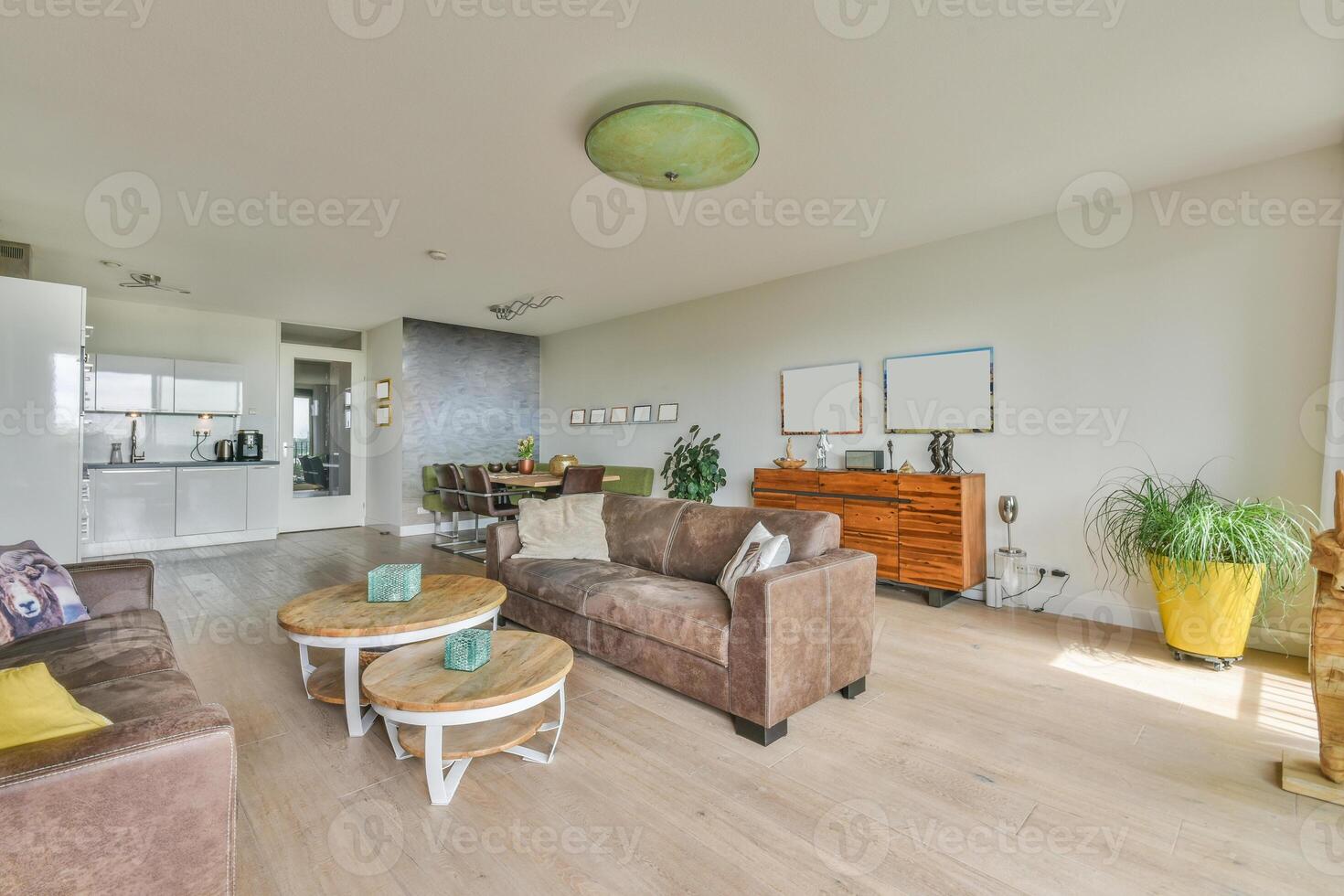A living room with a couch, coffee table and a television photo