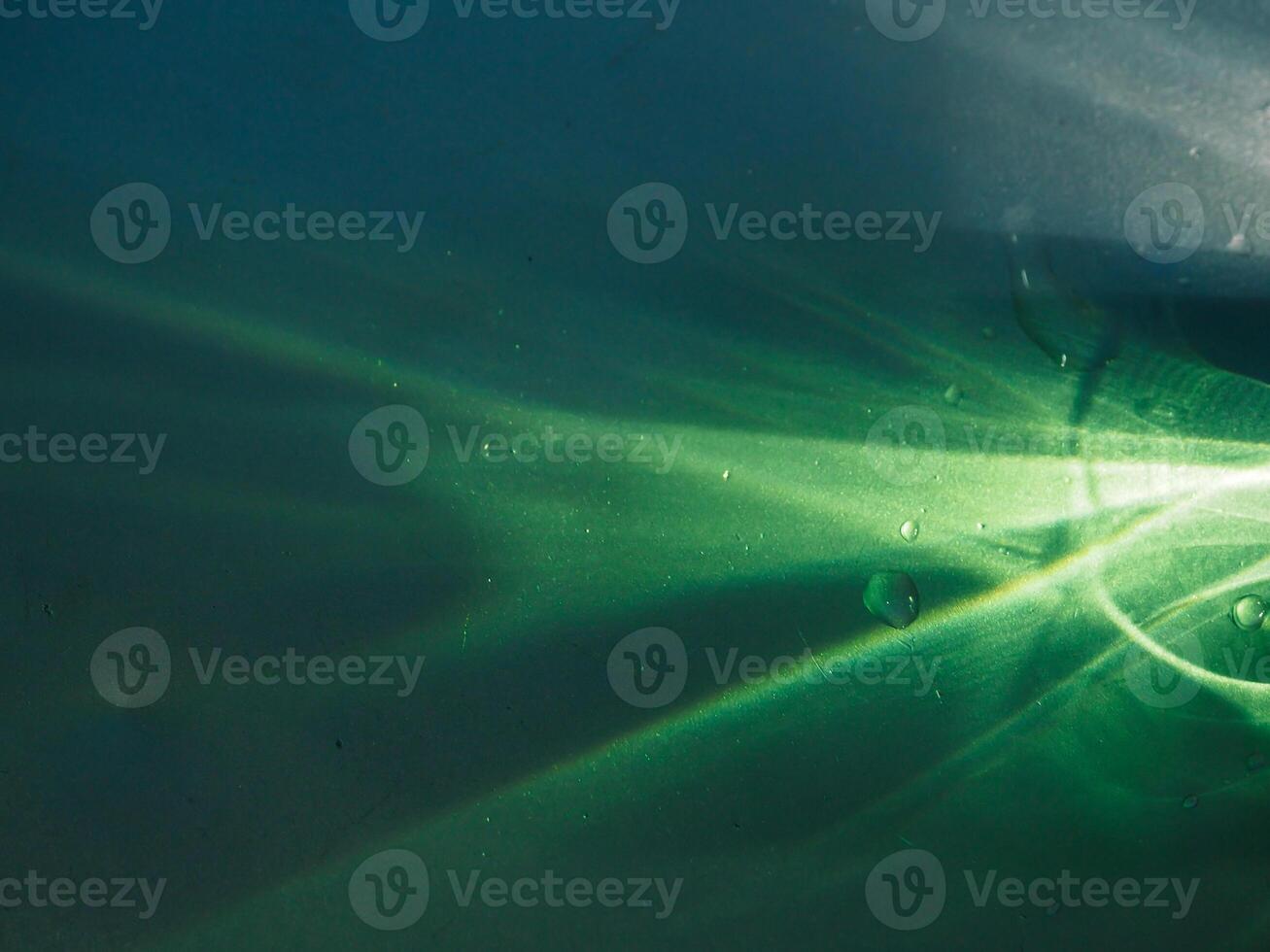 Green light reflecting in the dark for an abstract, mysterious or magical background. photo